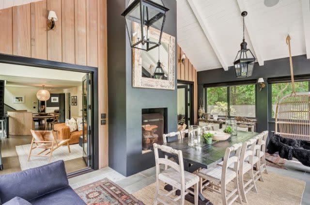 <p>The screened porch featuring a fireplace is the perfect place for family dinners.</p>