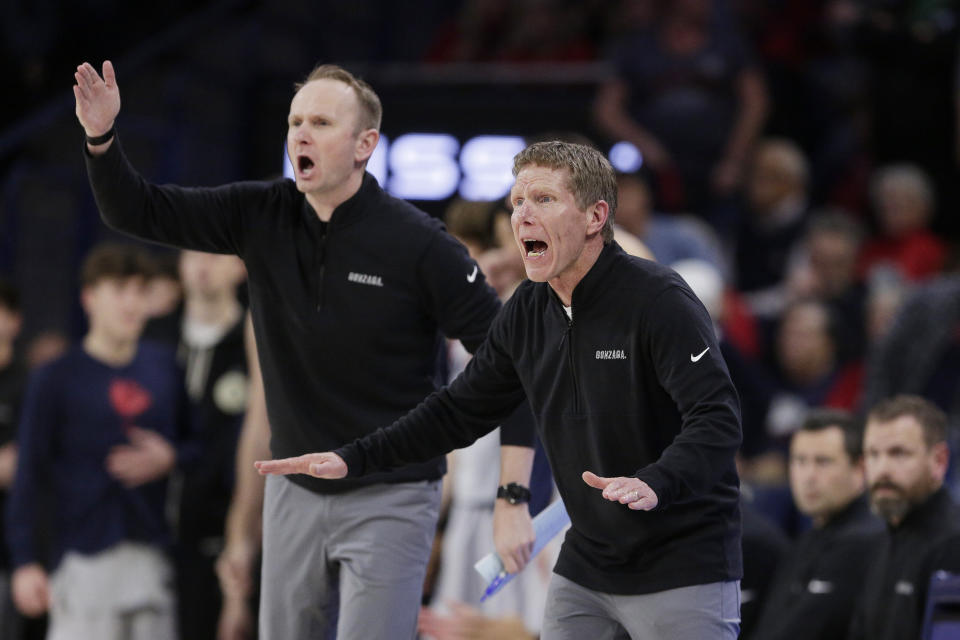 Gonzaga coach Mark Few, right, and assistant coach Stephen Gentry direct the team during the second half of an NCAA college basketball game against San Diego State, Friday, Dec. 29, 2023, in Spokane, Wash. (AP Photo/Young Kwak)