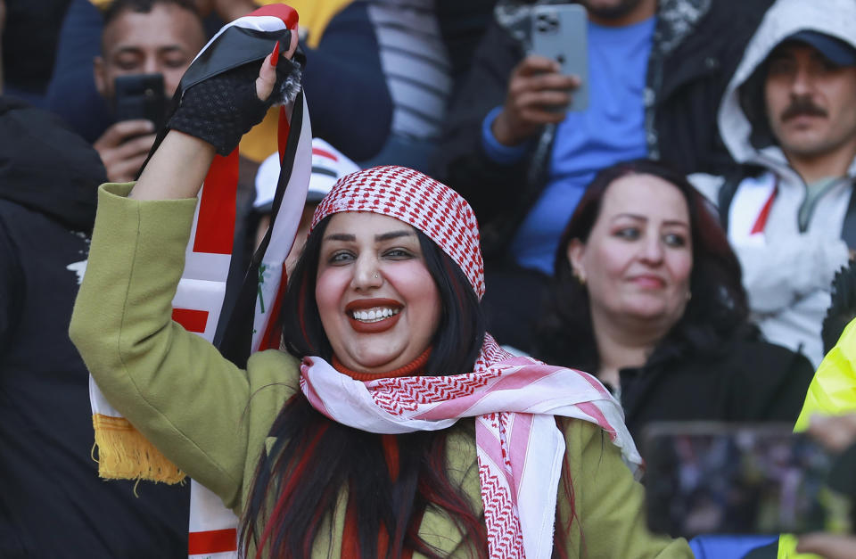 Iraqi soccer fan waves her country flag inside the stadium before the Arabian Gulf Cup football final between Iraq and Oman at the Basra International Stadium in Basra, Iraq, Thursday, Jan 19, 2023. (AP Photo/Nabil al-Jurani)