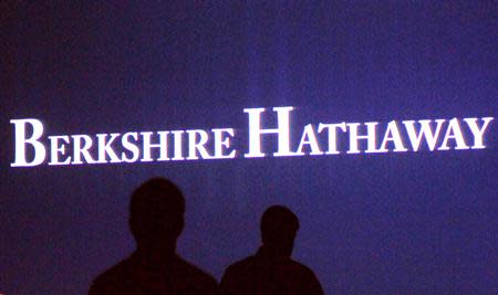Berkshire Hathaway shareholders walk by a video screen at the company's annual meeting in Omaha in this May 4, 2013 file photo. REUTERS/Rick Wilking/Files