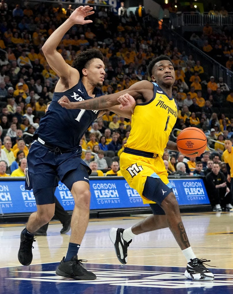 Marquette guard Kam Jones drives on Xavier guard Desmond Claude during the first half on Sunday.