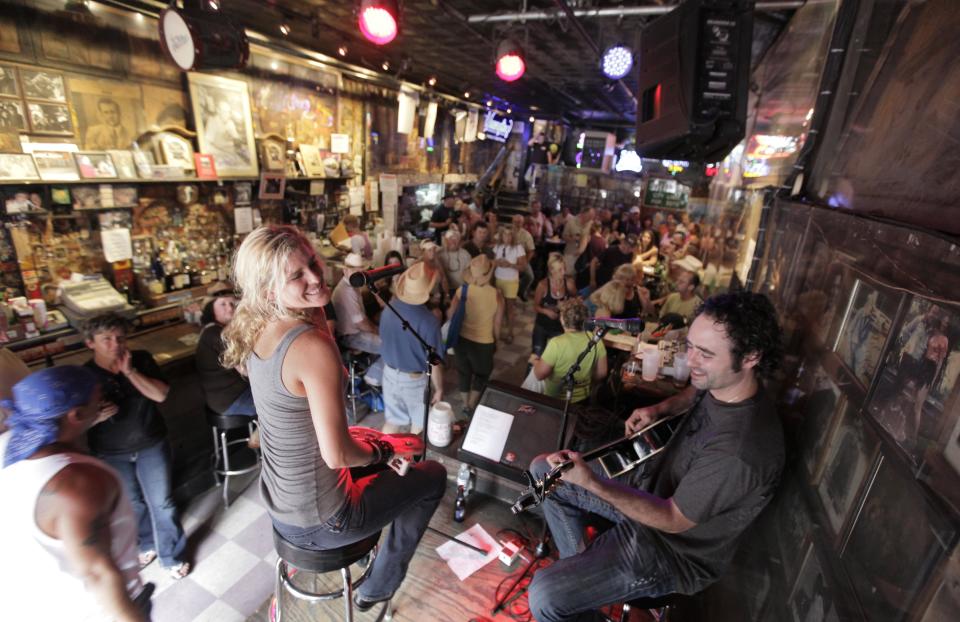 FILE -This June 9, 2010 photo shows Nichole Rapisardi and West Butler performing at Tootsies Orchid Lounge in Nashville, Tenn. Tourism comes alive in the Music City come summer, and many of the city's Nashville-based stars enjoying playing tourist, too. (AP Photo/M. Spencer Green, File)