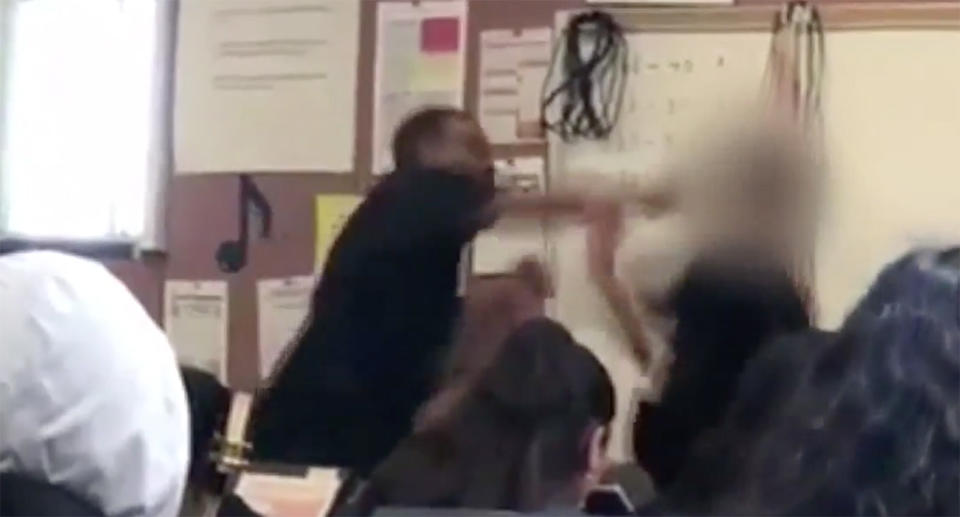 Riley can be seen taking a swing at the 14-year-old student in front of stunned students. Image: Yahoo Lifestyle