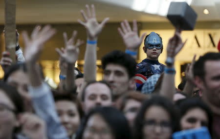 A boy dressed as Captain America awaits the start of the european premiere of "Avengers: Age of Ultron" at Westfield shopping centre, Shepherds Bush, London, April 21, 2015. REUTERS/Stefan Wermuth