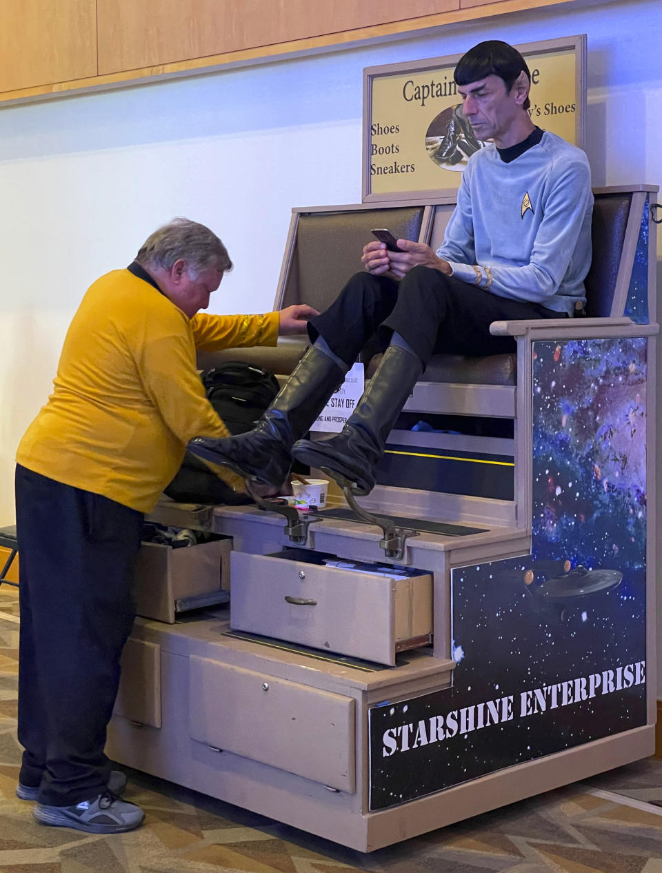 Daniel Golden, dressed as Captain Kirk, shines the shoes of Paul Forest, of Toronto, dressed as Spock, characters from "Star Trek," at day one of Comic-Con International on Thursday, July 21, 2022, in San Diego. (Photo by Max Ulichney/Invision/AP)