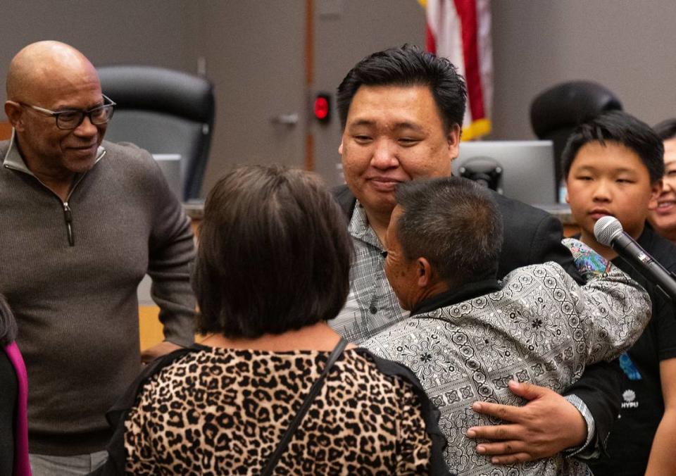 Interim District 2 Sacramento City Councilman Shoun Thao hugs his father Thai Thao after being sworn in on Tuesday, April 2, 2024.