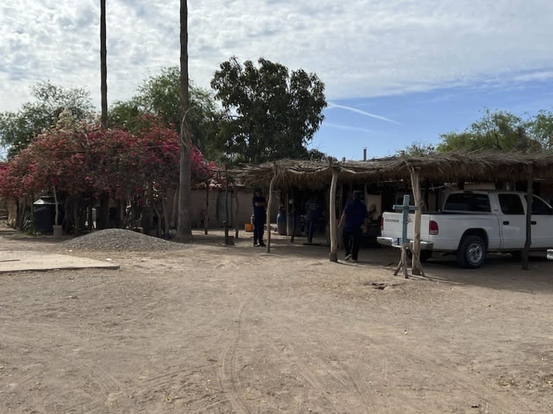 A cross stands at a home in Sonora, Mexico, is shown in 2022 while members of the Pascua Yaqui Tribe pick up cultural participants from their related tribal community. (Raymond V. Buelna via AP)