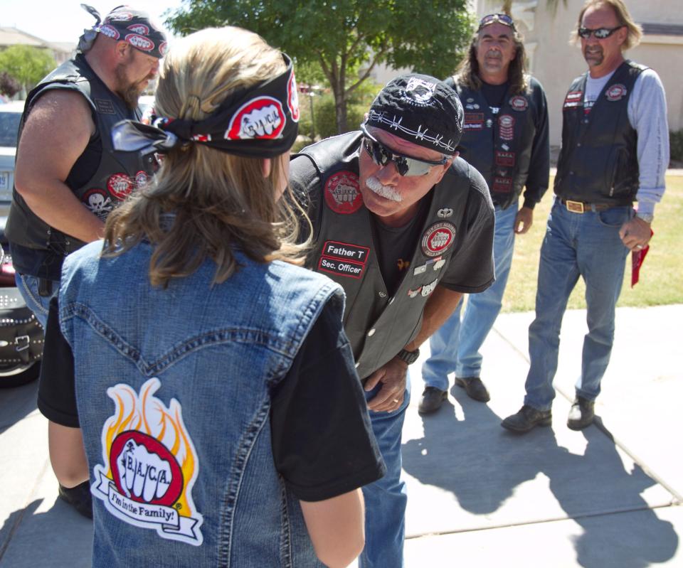 Members of Bikers Against Child Abuse in Arizona wearing their motto on their black leather vests and T-shirts: "No child deserves to live in fear."