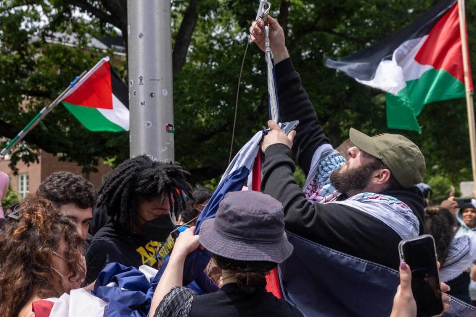 Pro-Palestinian demonstrators replace an American flag with a Palestinian flag Tuesday, April 30, 2024 at UNC-Chapel Hill. Police removed a “Gaza solidarity encampment” earlier Tuesday morning.