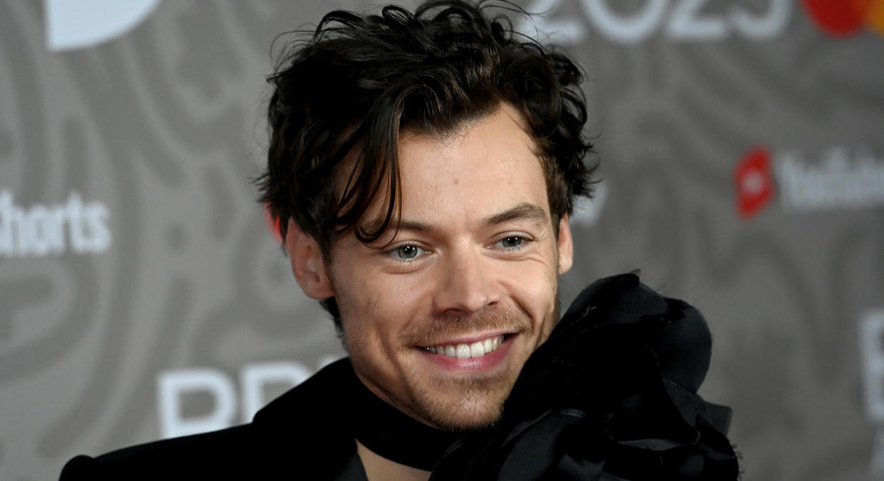 Harry Styles accessorised a plain black suit in a way only Harry Styles can. (Getty Images)