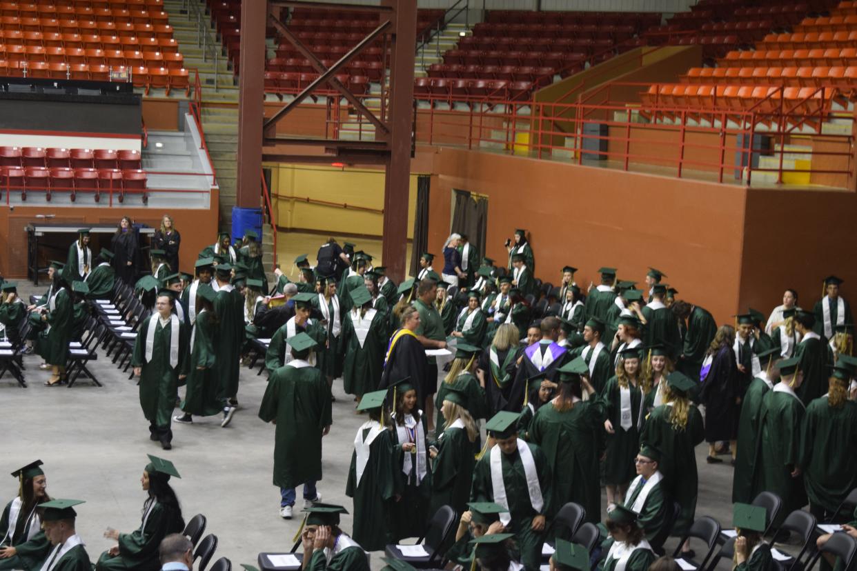 Members of the Salina South High School graduating class of 2022 gather behind the stage before their commencement ceremony Sunday evening at Tony's Pizza Events Center.