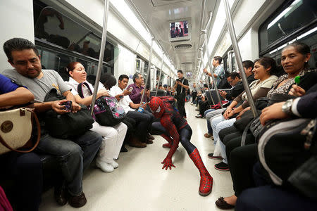 Moises Vazquez, 26, known as Spider-Moy, a computer science teaching assistant at the Faculty of Science of the National Autonomous University of Mexico (UNAM), who teaches dressed as a comic superhero Spider-Man, poses for a photograph on a subway on his way to work in Mexico City, Mexico, May 27, 2016. REUTERS/Edgard Garrido