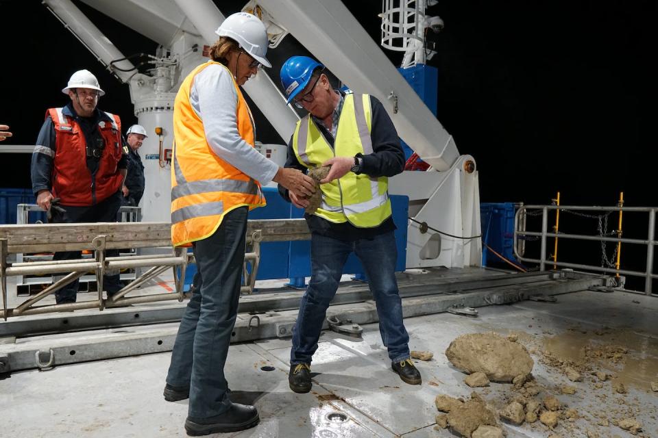 Samples being brought up from the seafloor is always a very exciting moment. Here, Chief Scientist A/ Prof Tom Hubble (right), inspects a freshly retrieved dredge sample late in the night at the end of his shift. Ali Jam Productions Photography, Author provided