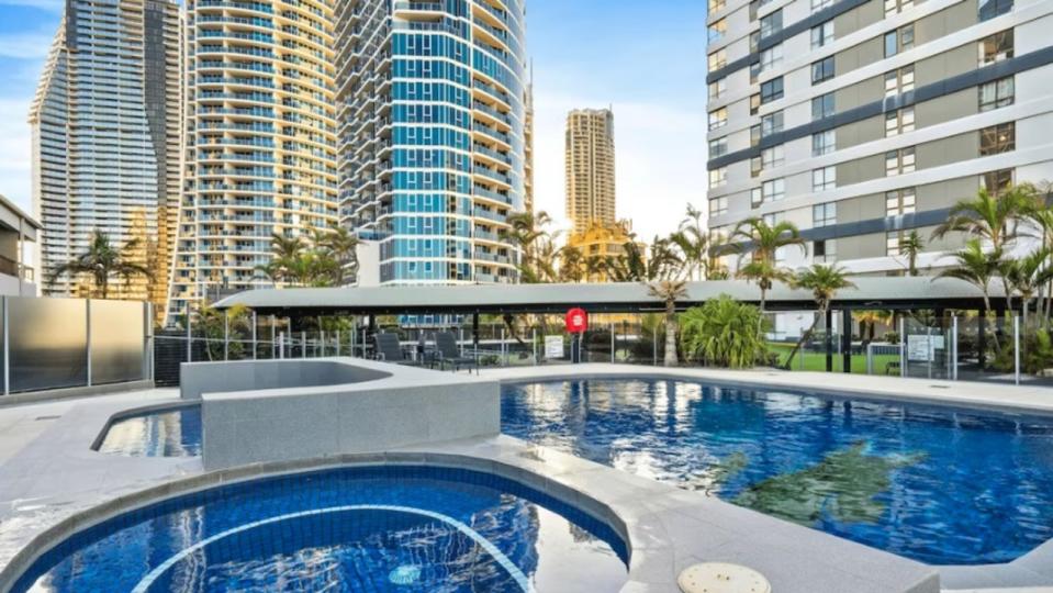 Two men were have drowned in a Surfers Paradise hotel pool after saving their relatives who could not swim.