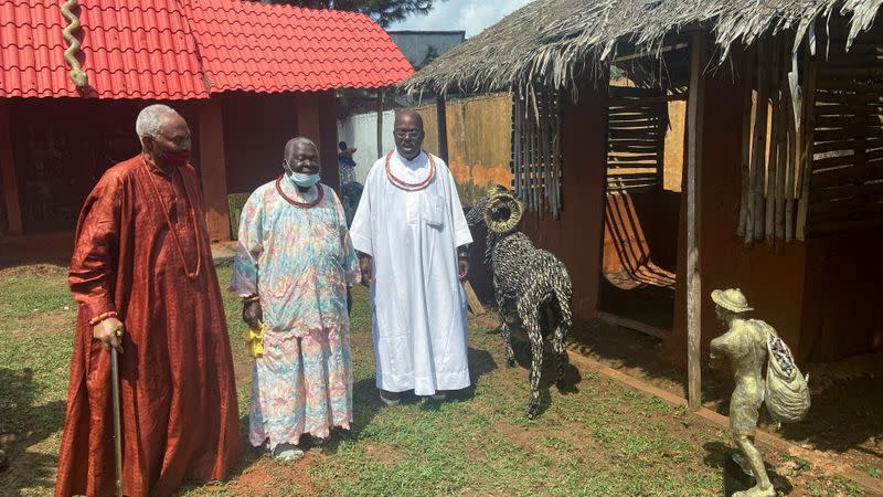 Iyase of Benin, Chief Sam Igbe holds a walking stick next to two other chiefs during the unveiling of Lucas Osarobo- Okoro's largest bronze work in Benin