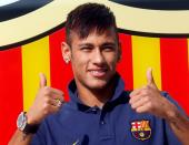 FILE PHOTO: Brazilian forward Neymar poses for photographs after completing his transfer from Santos to Barcelona in 2013 for 48.6 million euros ($54.01 million).