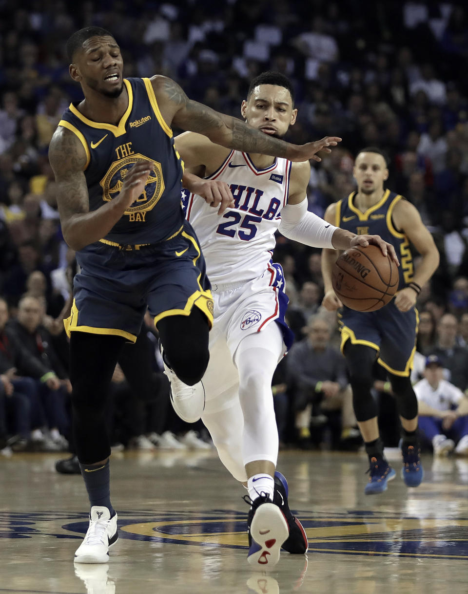 Philadelphia 76ers' Ben Simmons (25) drives the ball next to Golden State Warriors' Alfonzo McKinnie, left, during the first half of an NBA basketball game Thursday, Jan. 31, 2019, in Oakland, Calif. (AP Photo/Ben Margot)