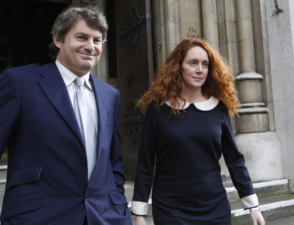 Rebekah Brooks, former chief executive of News International and her husband Charlie Brooks leave the High Court in London after giving evidence to the Leveson Inquiry, Friday, May 11, 2012. The Leveson Inquiry is Britain's media ethics probe that was set up in the wake of the scandal over phone hacking at Rupert Murdoch's News of the World, which was shut in July 2011 after it became clear that the tabloid had systematically broken the law. (AP Photo/Sang Tan)