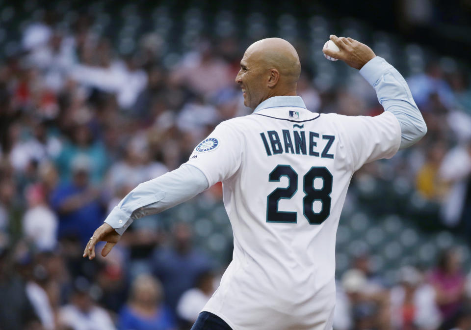 FILE - Former Seattle Mariners outfielder Raul Ibañez throws out the first pitch before the Mariners' baseball game against the New York Yankees, July 21, 2017, in Seattle. Reynolds and Raul Ibañez will be the managers for the All-Star Futures Game in Seattle in July. (AP Photo/Ted S. Warren, File)