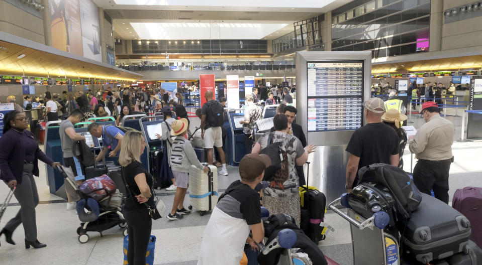 Travelers make their way through the Tom Bradley International Terminal at LAX on Wednesday, Aug. 30, 2023, in Los Angeles. With Labor Day weekend just days away, airports and roadways are expected to be busy as tens of thousands of Southern Californians travel out of town. (Dean Musgrove/The Orange County Register via AP)