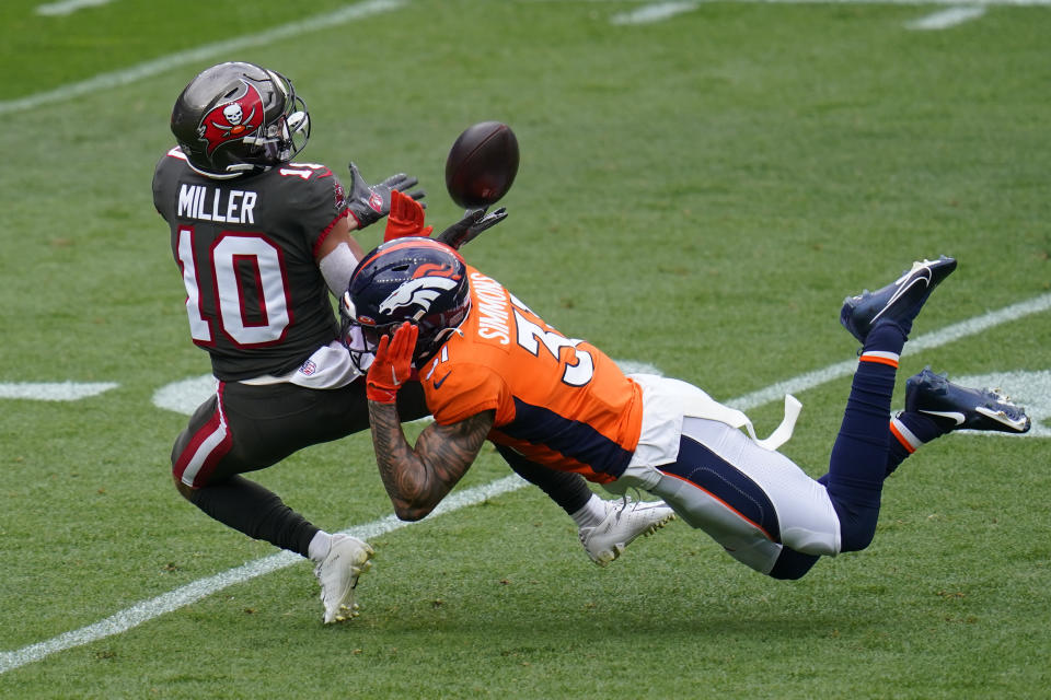 Tampa Bay Buccaneers wide receiver Scott Miller (10) make a catch as Denver Broncos free safety Justin Simmons defends during the first half of an NFL football game Sunday, Sept. 27, 2020, in Denver. (AP Photo/Jack Dempsey)