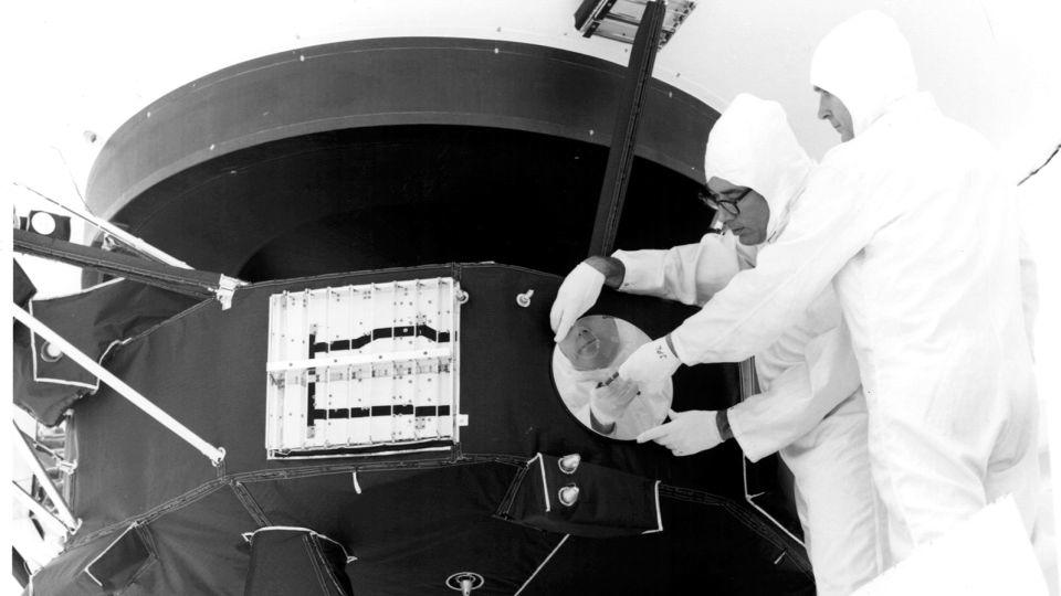 Engineers can be seen securing the cover over the Voyager 1 Golden Record in 1977. - NASA/JPL-Caltech