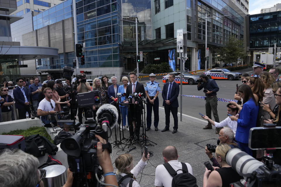 Chris Minns, premier of New South Wales state, center, speaks to media at Bondi Junction in Sydney, Sunday, April 14, 2024, after several people were stabbed to death at a shopping center Saturday. Police have identified Joel Cauchi, 40, as the assailant that stabbed several people to death at a busy Sydney shopping center Saturday before he was fatally shot by a police officer. (AP Photo/Rick Rycroft)