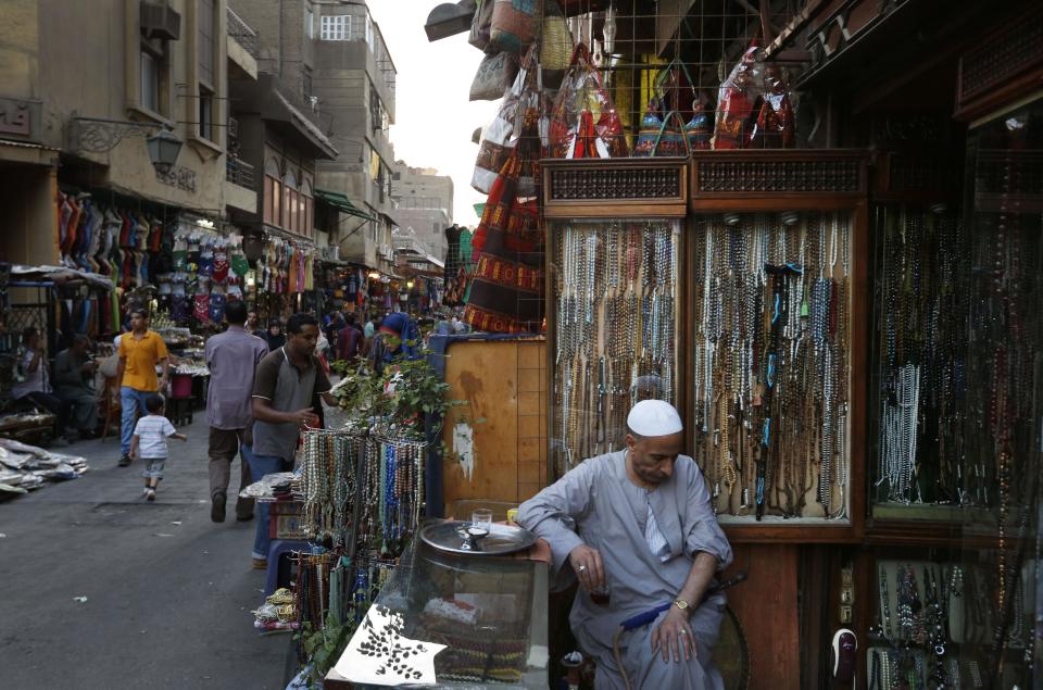 An Egyptian vendor waits for customers in the Khan El-Khalili market, normally a popular tourist destination, in Cairo, Egypt, Monday, Sept. 9, 2013. Before the 2011 revolution that started Egypt's political roller coaster, sites like the pyramids were often overcrowded with visitors and vendors, but after a summer of coup, protests and massacres, most tourist attractions are virtually deserted to the point of being serene. (AP Photo/Lefteris Pitarakis)