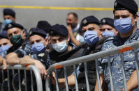 Lebanese policemen wear masks to help curb the spread of the coronavirus during a protest against a proposed general amnesty law in parliament, in Beirut, Lebanon, Thursday, May 28, 2020. (AP Photo/Hussein Malla)