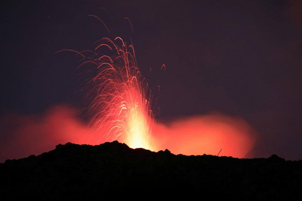 Spectacular eruptions from Mount Etna lit up the sky during the night in Catania, Italy, December 8, 2019. Picture taken December 8, 2019. REUTERS/Antonio Parrinello