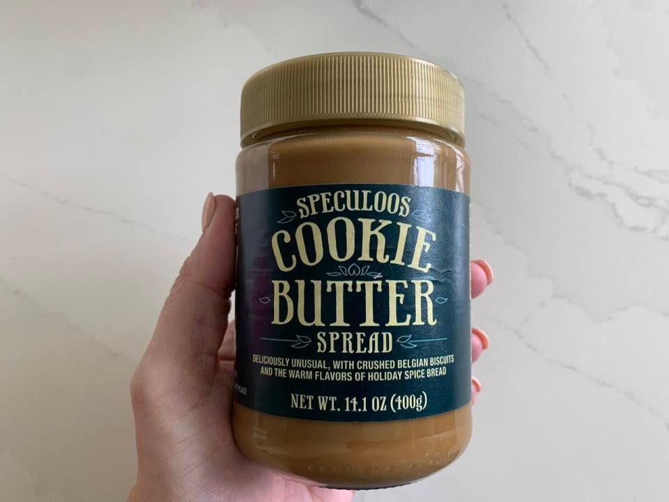 A jar of Trader Joe's speculoos cookie butter on a marble countertop.