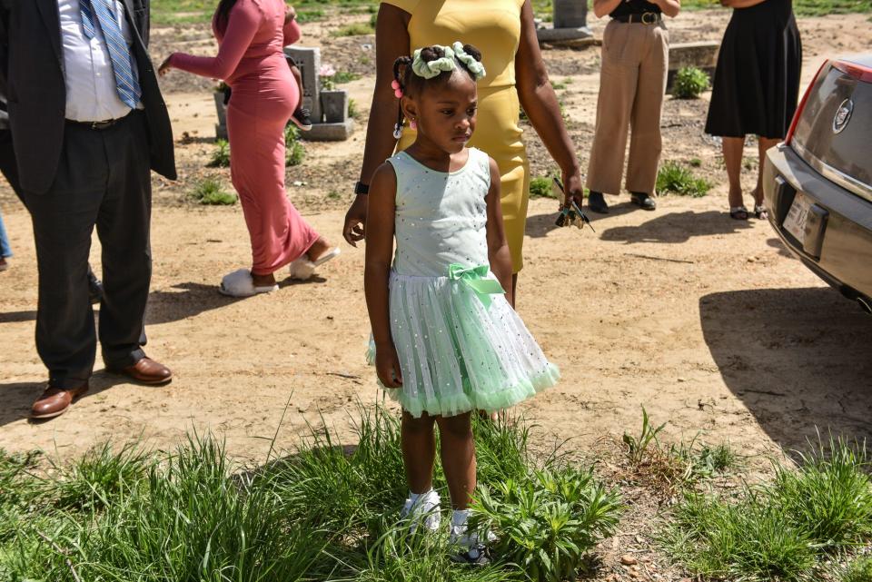 A young mourner is seen at the burial for two-year-old Aubree Green, killed in the March 24 deadly tornado in Silver City.