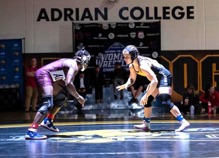 Coldwater alumni and current Adrian College Bulldog Zoe Nowicki faces off with Blanche ‘Nina’ Kemu Makem of Augsburg University in the national championship match at 136 pounds this past Saturday