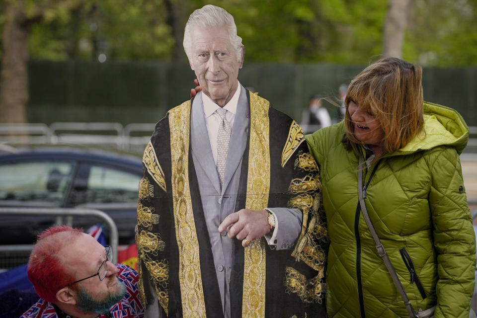 A woman poses next to a life-size cardboard cutout of Britain's King Charles III along the King's Coronation route at The Mall in London, Thursday, May 4, 2023. The Coronation of King Charles III will take place at Westminster Abbey on May 6. (AP Photo/Andreea Alexandru)