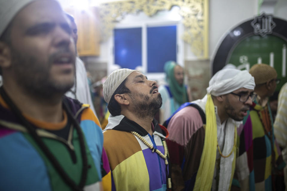 Members of the Sufi Karkariya order dance during a religious celebration of the birthday of the prophet Muhammed, in Aroui, near Nador, east of Morocco, Monday, Oct. 18, 2021. (AP Photo/Mosa'ab Elshamy)