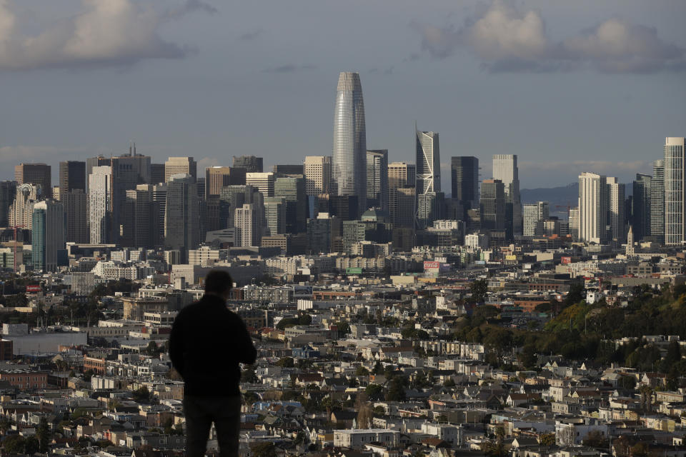 FILE - In this March 16, 2020, file photo, a person looks toward the skyline from Bernal Heights Hill in San Francisco. According to new data from the U.S. Census Bureau released Thursday, Aug. 12, 2021, California's Asian population grew by 25% in the past decade, making them the fastest growing ethnic group in the nation's most populous state. (AP Photo/Jeff Chiu, File)