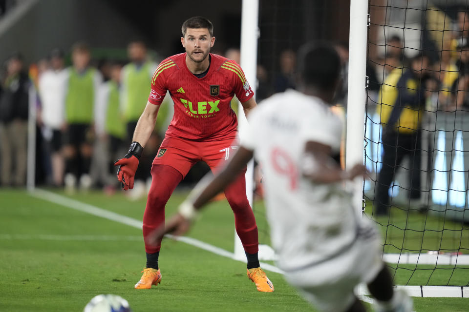 Los Angeles FC goalkeeper John McCarthy (77) watches as Vancouver Whitecaps forward Sergio Córdova (9) shoots during the first half of an MLS soccer match in Los Angeles, Saturday, June 24, 2023. (AP Photo/Ashley Landis)