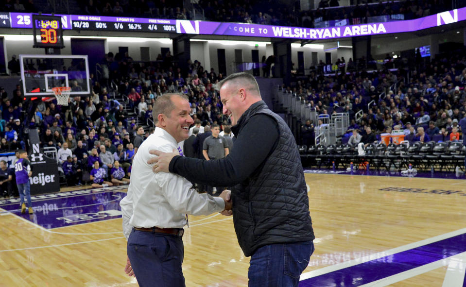Northwestern AD Jim Phillips congratulates football coach Pat Fitzgerald as he was being honored for being named Big Ten Coach of the year on Dec. 21, 2018. (AP)