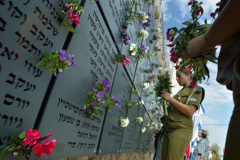 Israeli soldiers lay flowers at a war memorial center in Israel on the anniversary of the Yom Kippur War between Israel and, Syria and Egypt which began October 6, 1973. File Photo by Orel Cohen/UPI