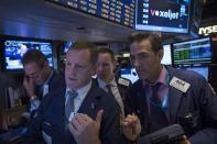 Specialist trader Chris Malloy (C) gives a price to traders on the floor of the New York Stock Exchange, October 18, 2013. REUTERS/Brendan McDermid