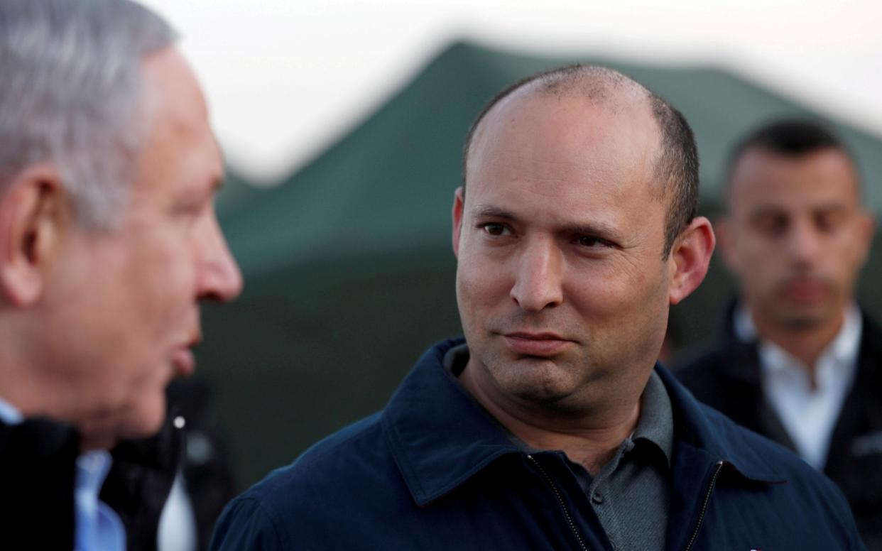 Naftali Bennett, then defence minister, and Prime Minister Benjamin Netanyahu during a visit to an Israeli army base in the Israeli-occupied Golan Heights in 2019 - REUTERS