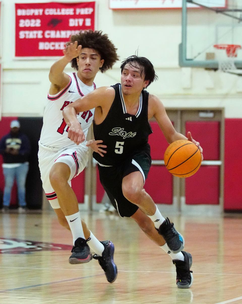 Sunnyslope guard John Mattingly (5) drives against Brophy guard Malaki Garnica (14) during a game at Brophy Prep High School in Phoenix on Dec. 22, 2023.