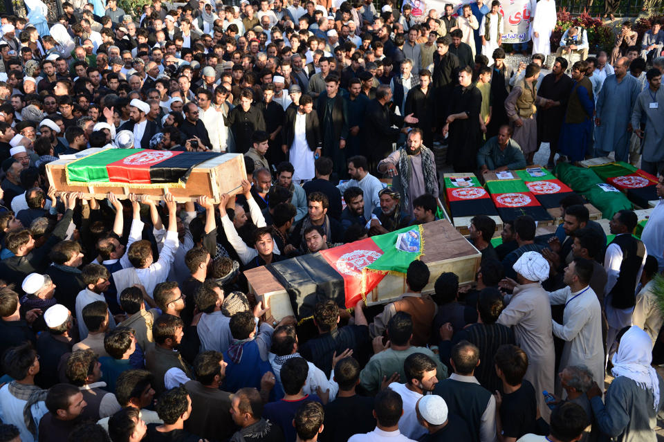 <p>Afghan protesters carry coffins of victims as they shout against the Islamic State group following a mosque attack that killed 33 people in Herat on August 2, 2017. (Photo: Hoshang Hashimi/AFP/Getty Images) </p>