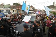 Demonstrators surround the vehicle carrying former Guatemalan President Otto Perez upon arrival at the Matamoros military barracks in Guatemala City on September 3, 2015