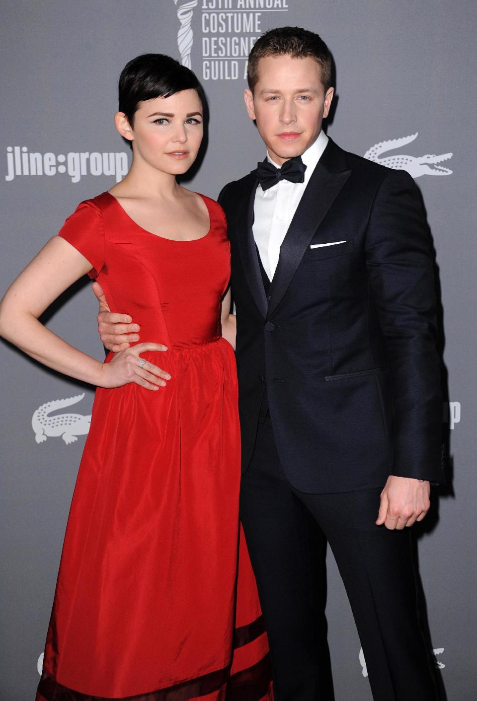 FILE - This Feb. 19, 2013 file photo shows Ginnifer Goodwin, left, and Josh Dallas at the 15th Annual Costume Designers Guild Awards in Beverly Hills. The actors, who play Snow White and Prince Charming on ABC’s “Once Upon a Time,” are expecting their first child together. Goodwin’s representative confirmed the news, first reported by People magazine, on Wednesday, Nov. 20. No other details were available. The couple became engaged last month. (Photo by Jordan Strauss/Invision/AP, File)