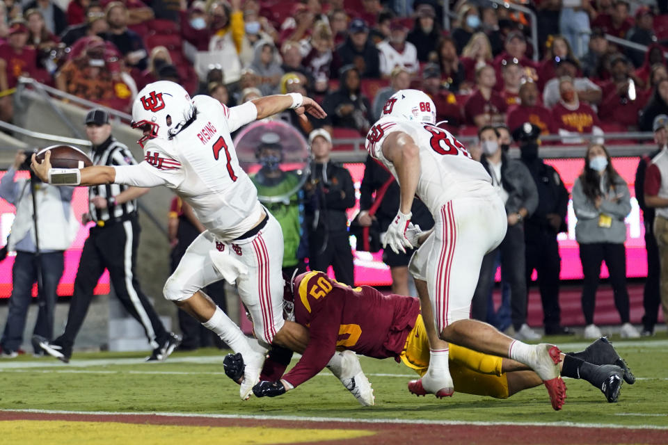 Utah quarterback Cameron Rising (7) scores a rushing touchdown past Southern California defensive lineman Nick Figueroa (50) during the second half of an NCAA college football game Saturday, Oct. 9, 2021, in Los Angeles. (AP Photo/Marcio Jose Sanchez)