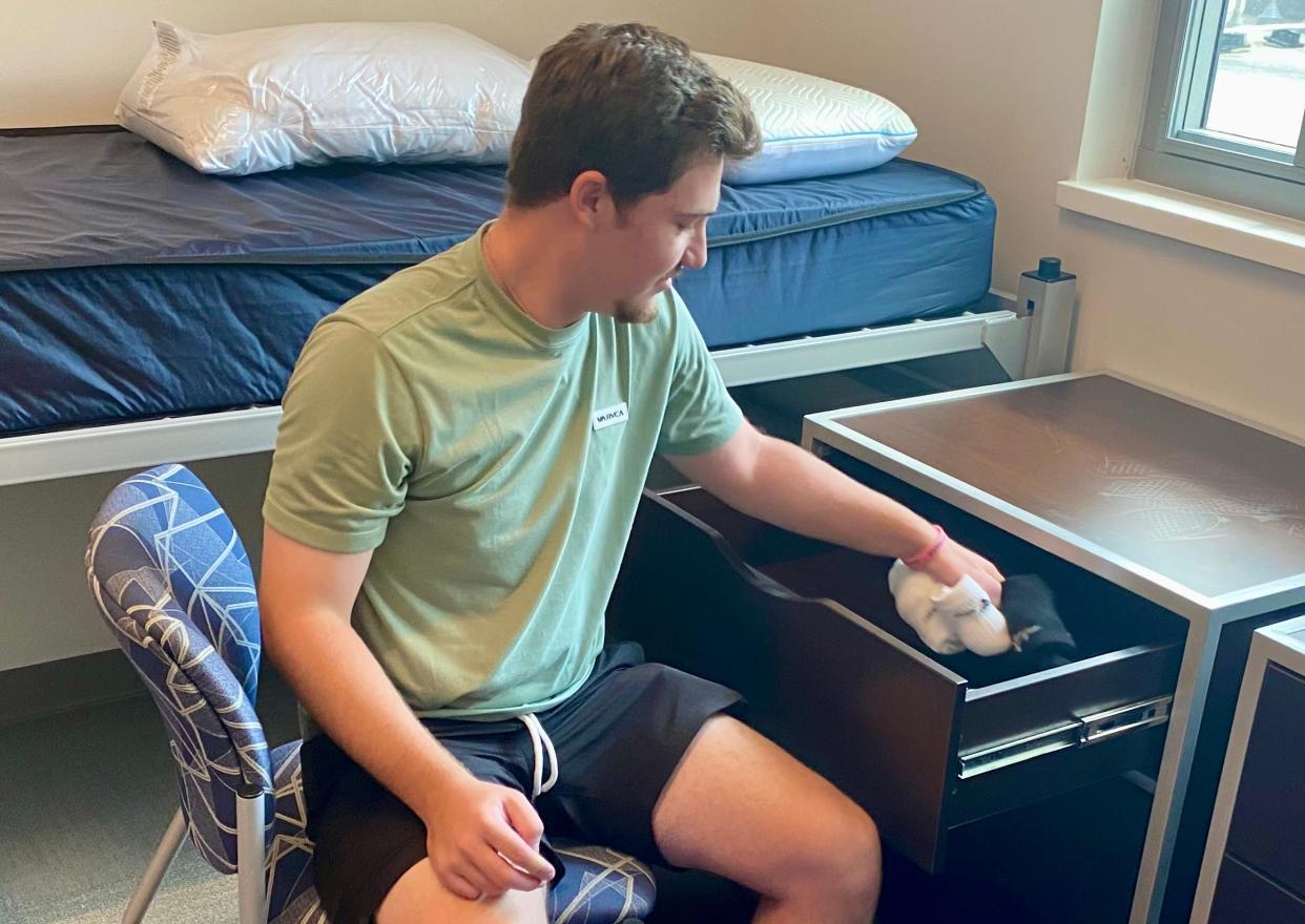 Noah Sperling, of Irvine, Calif., unpacks in New Hall at Columbia College on Wednesday, freshman move-in day at the college.
