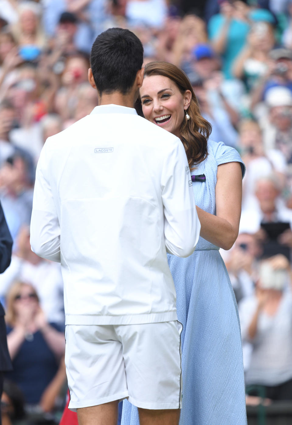 LONDON, ENGLAND - JULY 14: Catherine, Duchess of Cambridge presents Novak Djokovic with the winner's trophy after winning his Men's Singles final against Roger Federer of Switzerland during Day thirteen of the Wimbledon Tennis Championships at All England Lawn Tennis and Croquet Club on July 14, 2019 in London, England. (Photo by Karwai Tang/Getty Images)