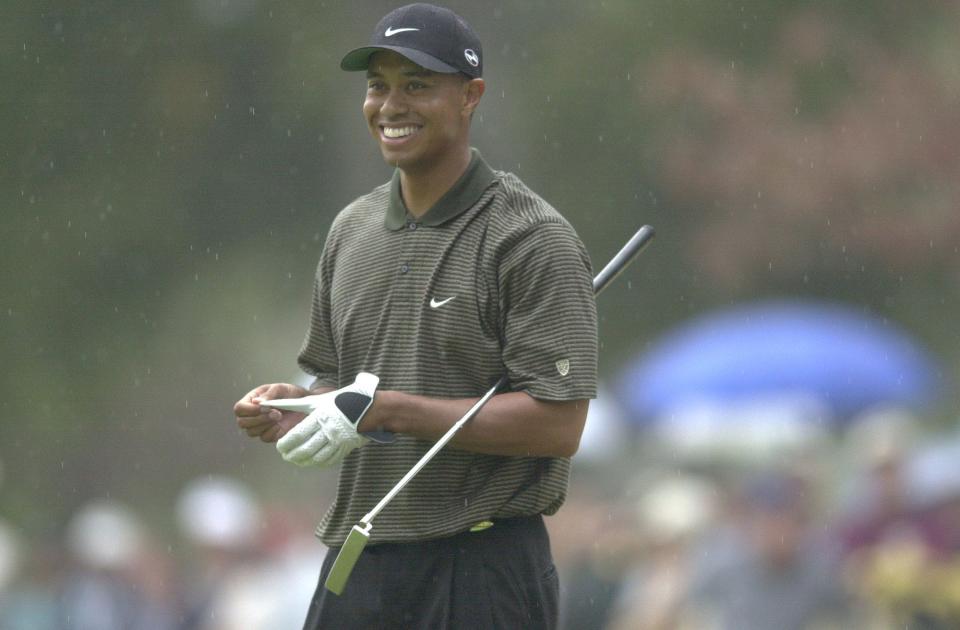 4 Nov. 2000: Tiger Woods smiles as he waits to putt on the 13th green during the third round of the Tour Championship at the East Lake Golf Club in Atlanta, Georgia. Woods is tied for the lead with Vijay Singh at 10 under par. DIGITAL IMAGE. Mandatory Credit: Harry How/ALLSPORT