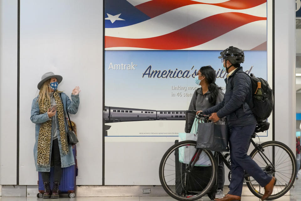 Travelers wait for their trains, Tuesday, Nov. 24, 2020, in New York's Penn Station. Gov. Andrew Cuomo urged New Yorkers to just say no to Thanksgiving gatherings to help reduce COVID-19 infections and hospitalizations, which he said are rising at a dangerous level. (AP Photo/Mary Altaffer)